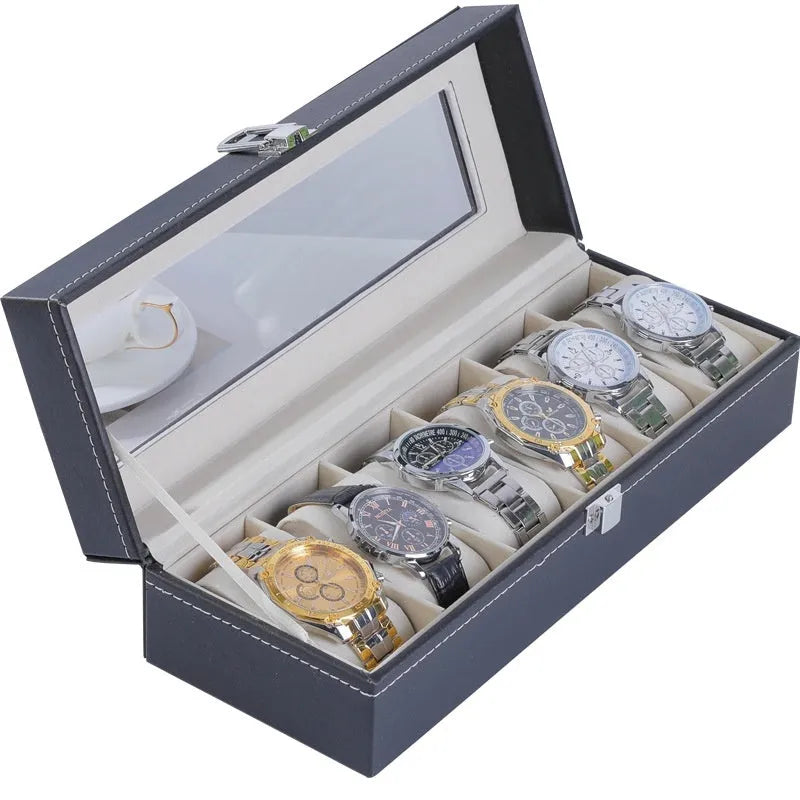 Grey leather watch storage box with clear dustproof lid showing multiple watch compartments inside.