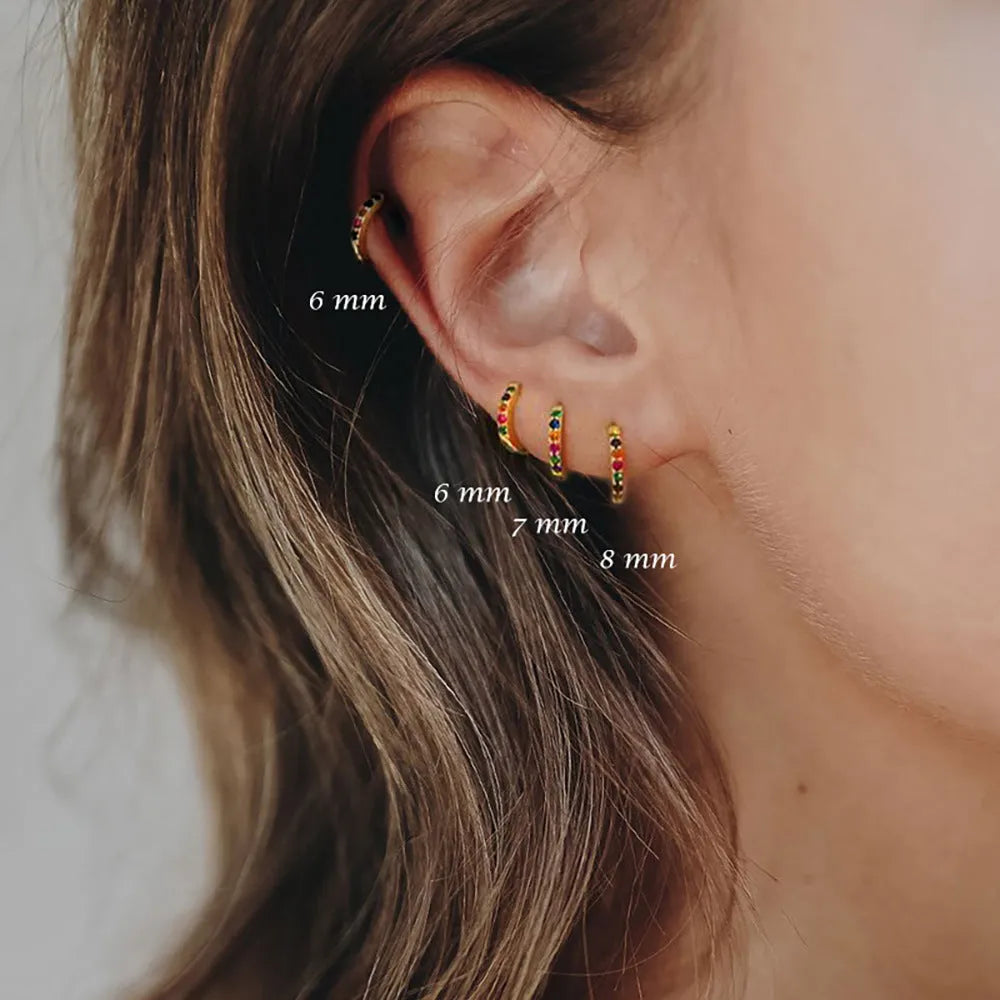 A pair of perforated circle stud earrings in a choice of gold, rose gold, or silver colour.
