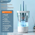 White rechargeable electric makeup brush cleaner with USB cable on a table.