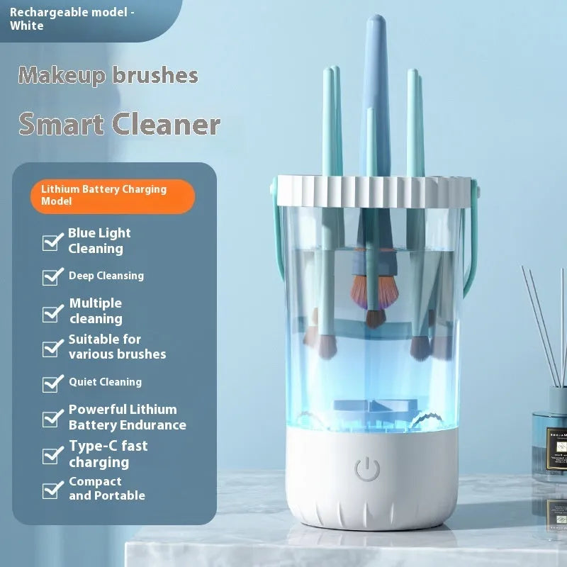White rechargeable electric makeup brush cleaner with USB cable on a table.