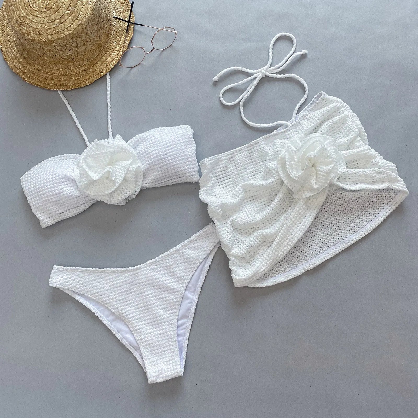 Women's white 3D flower split bikini set with skirt, bra, and briefs on a mannequin