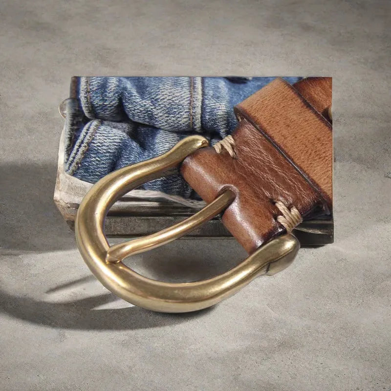 Men's brown genuine cowhide leather belt with a copper pin buckle on a jeans background.