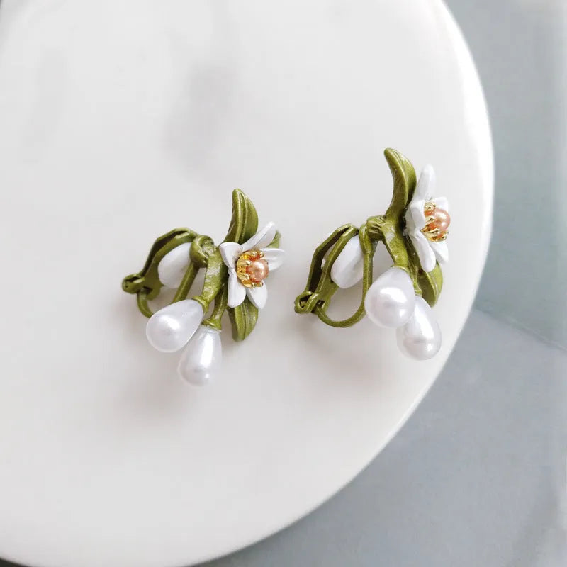 Alloy flower ear stud and matching clip-on earring pair with sterling silver needle camellia design.