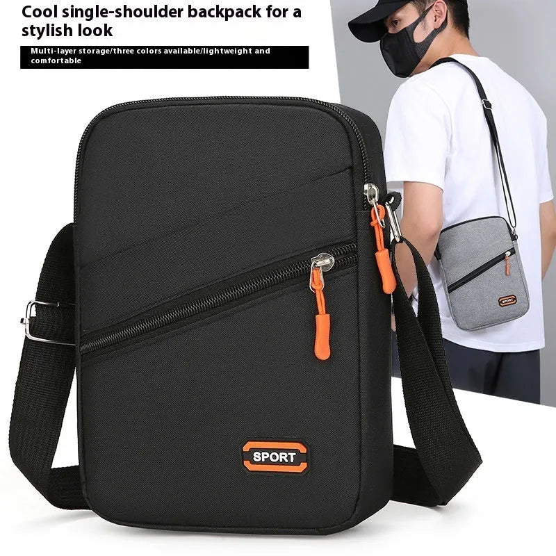 Oxford cloth crossbody commuter bag with contrast detailing in silver grey, black, or navy blue