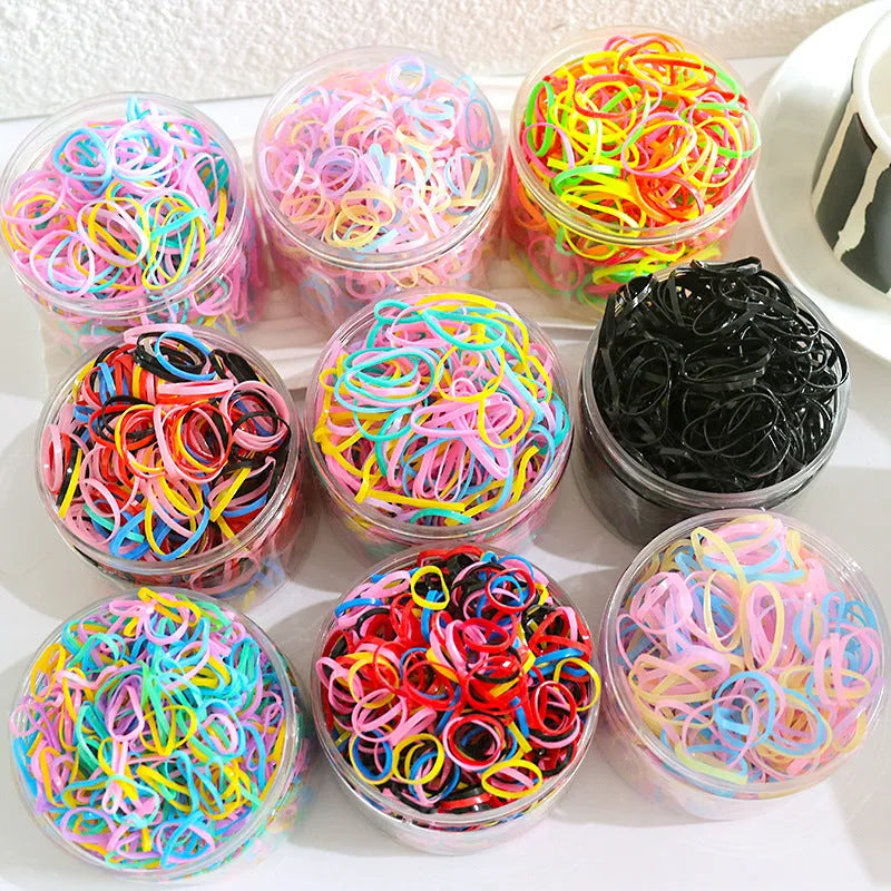 Pack of multicolour TPU baby hair ties for toddlers in a clear reusable container.