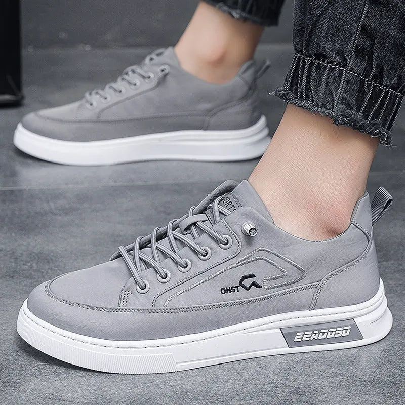 Grey men's canvas lace-up sneakers with stitching detail and a low-top round toe design.