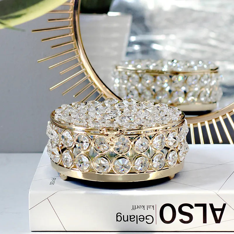 French gold metal jewelry box with a clear crystal glass front panel on display.
