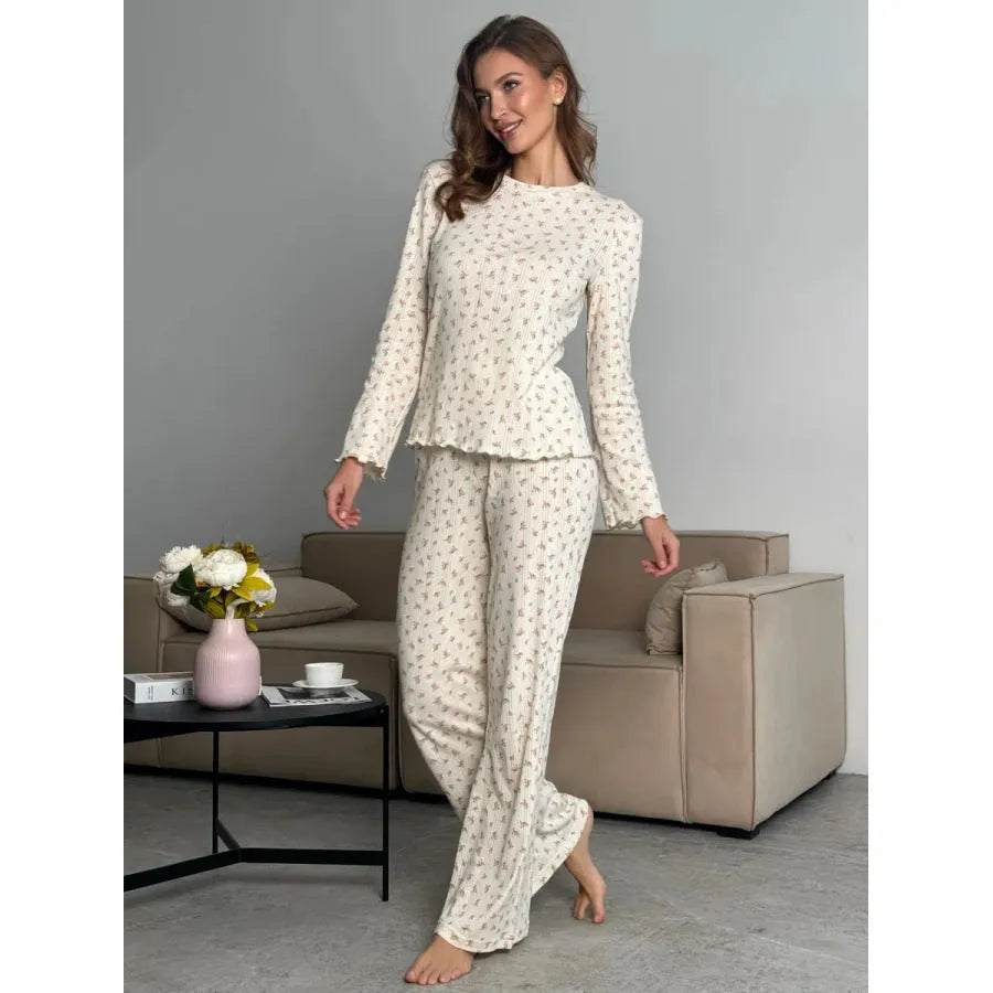 White floral print women's pyjama set with bell sleeve top and wide-leg trousers.