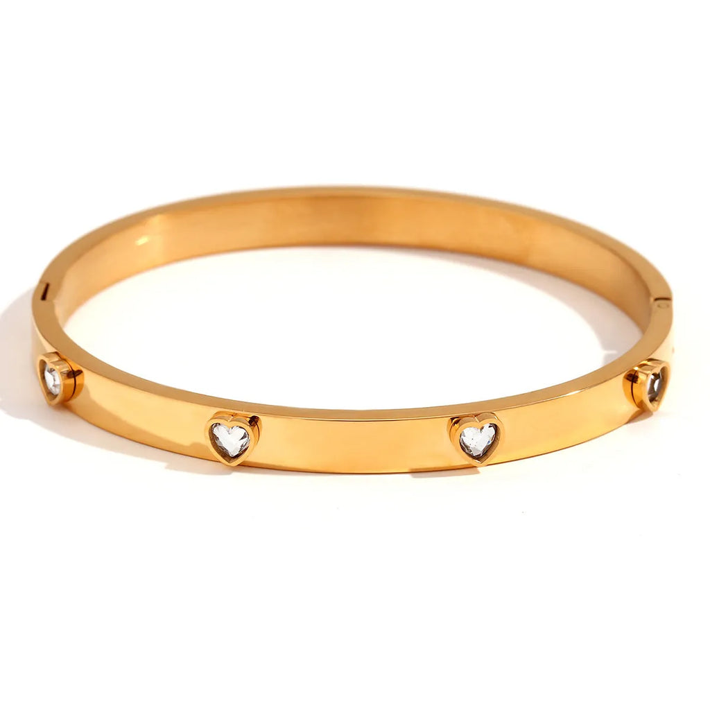 Stainless steel peach heart bracelet for women in a golden electroplated finish.