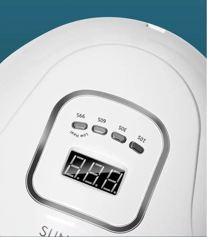 White nail polish quick-drying baking lamp dryer with dual UV and LED light sources on a clean surface.