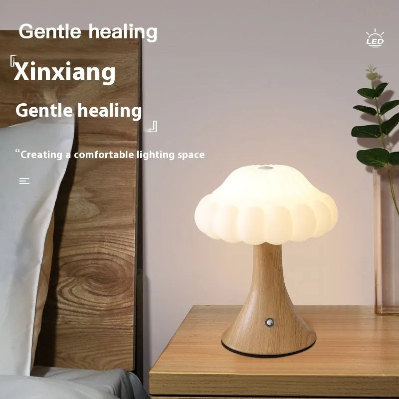 Mushroom-shaped USB rechargeable touch lamp in wood grain finish on table