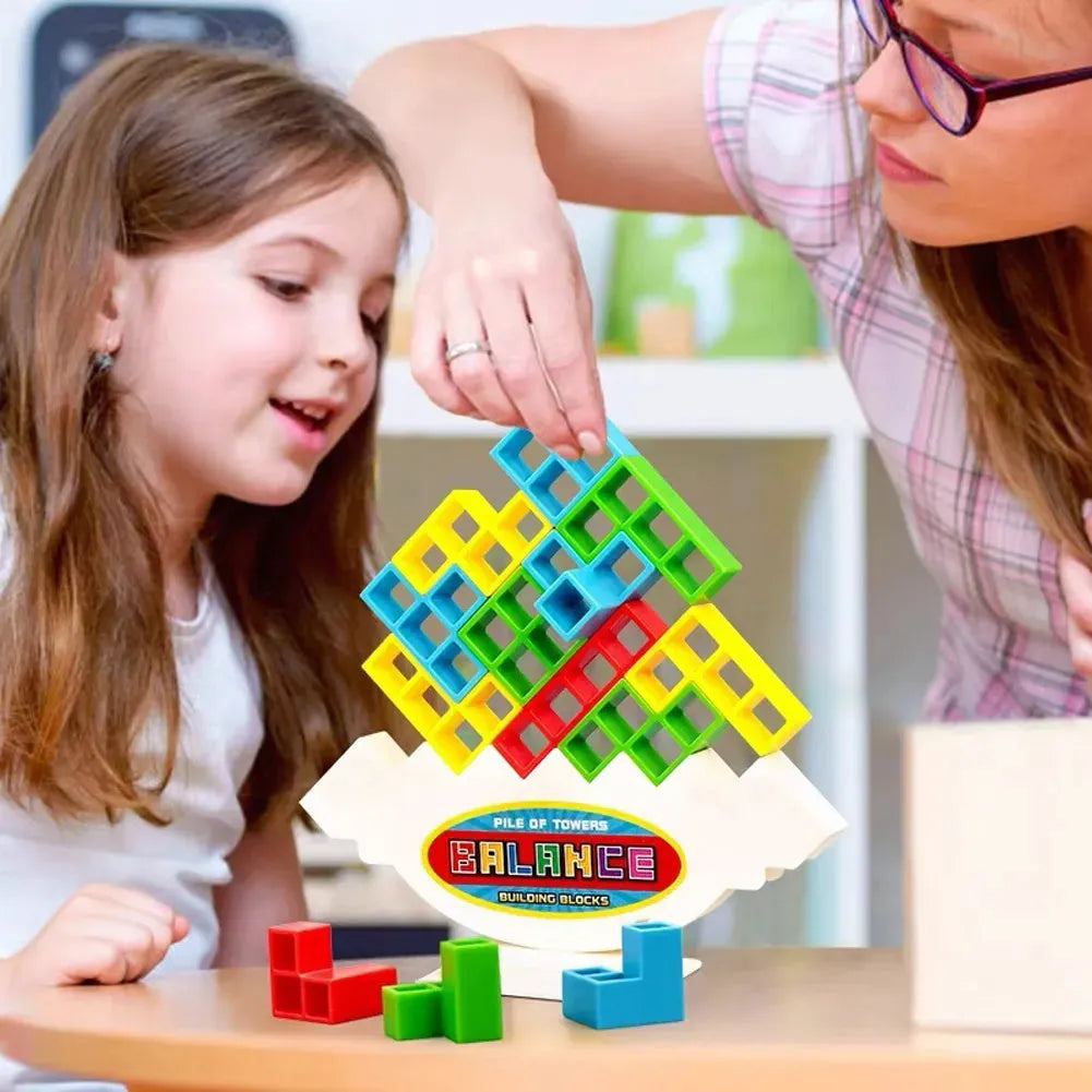 Plastic balance stacking game with 16 colourful building blocks, chassis and base on table