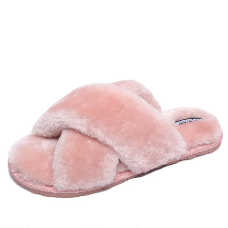 Cross-strap open-toe fur slippers in black with a textured sole, shown from the side.