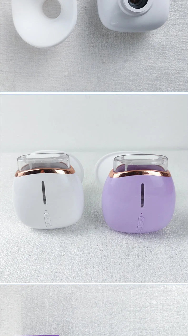 White and purple portable eye humidifier device with USB charging cable on a table.