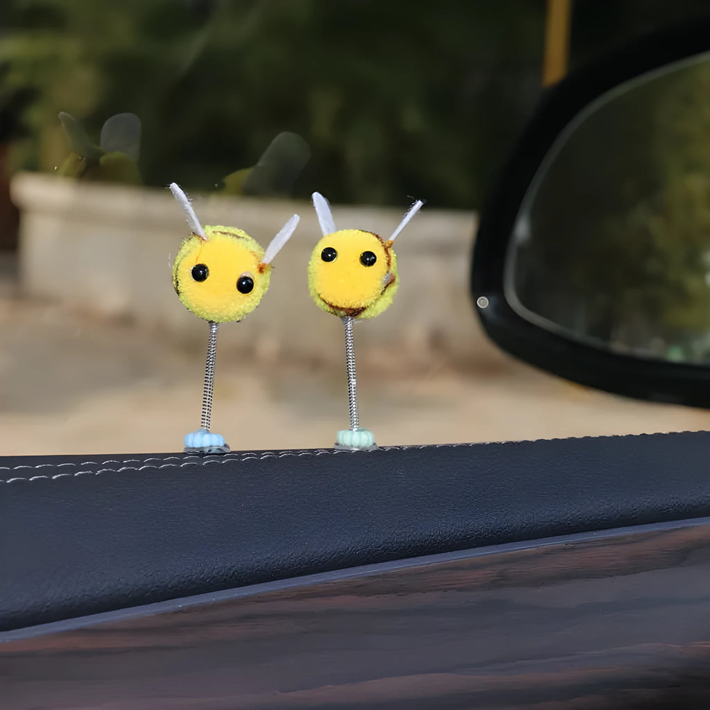 Soft fur bee car decoration on a swing spring for dashboard personalisation.