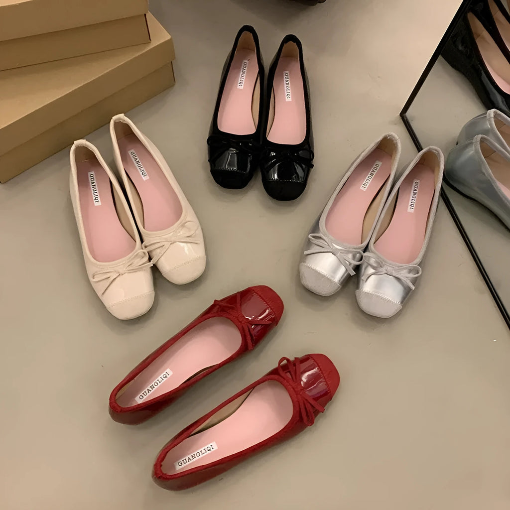 Wine red Mary Jane ballet flats with a bow and square toe on a rubber sole.