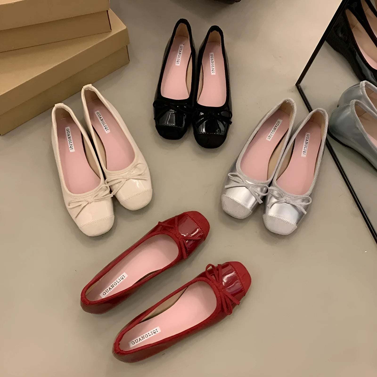Wine red Mary Jane ballet flats with a bow and square toe on a rubber sole.