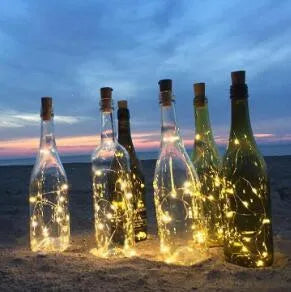2 metre long copper wire LED light string wrapped around a glass wine bottle with 20 small white LEDs.