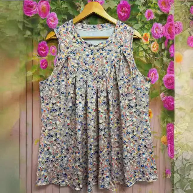 Black floral print sleeveless vest on hanger showing round neckline and loose fit for plus sizes