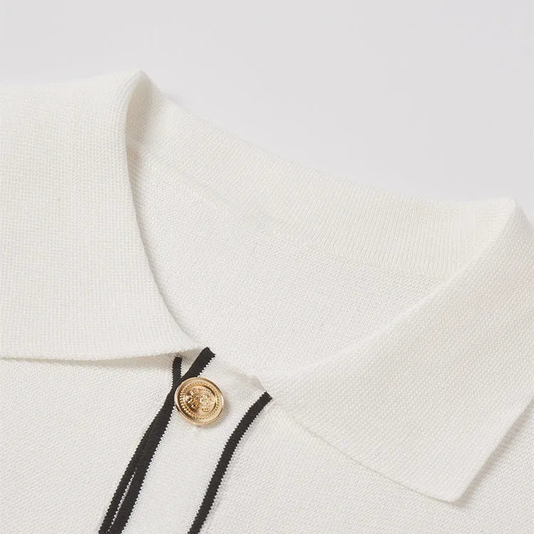 White short sleeve women's cardigan with dark contrasting lapels laid flat.