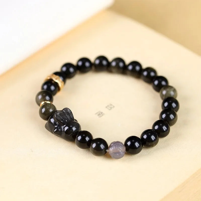 Handmade lying rabbit obsidian bracelet with Jin Yaoshi beads and brass details in national style.