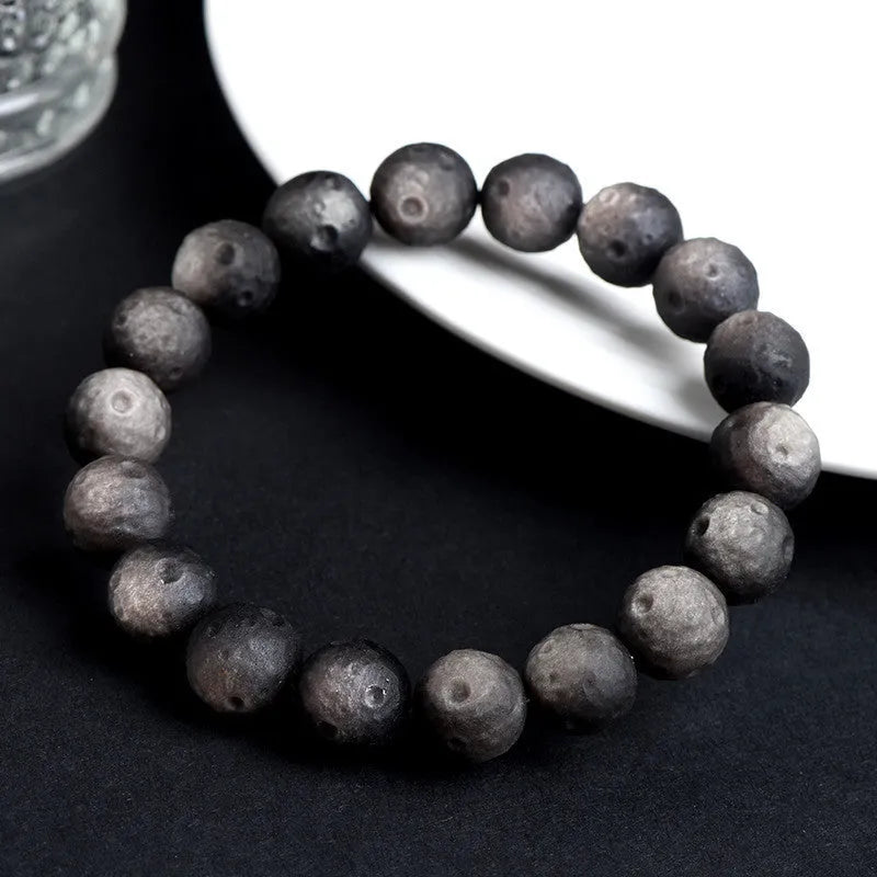 Natural obsidian crater ball bracelet with textured beads in silver meteorite finish