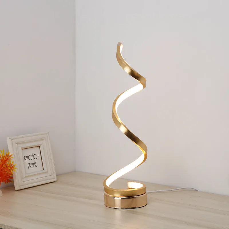 Minimalist black LED table lamp with aluminium shade on bedside table