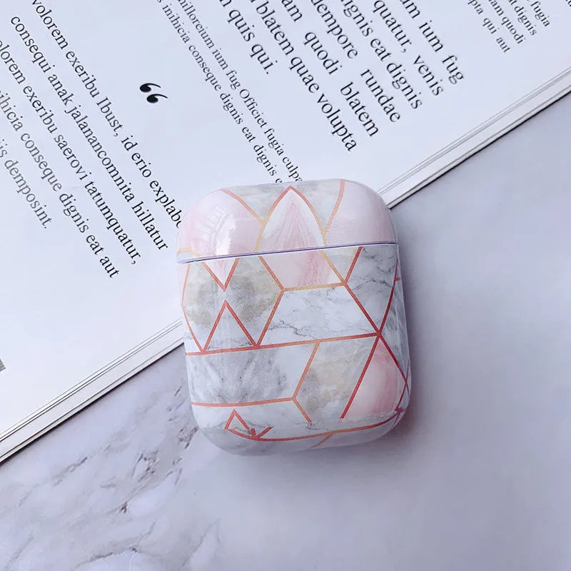 Hard white marble-pattern PC protective case fitted on an AirPods wireless earbud charging box.