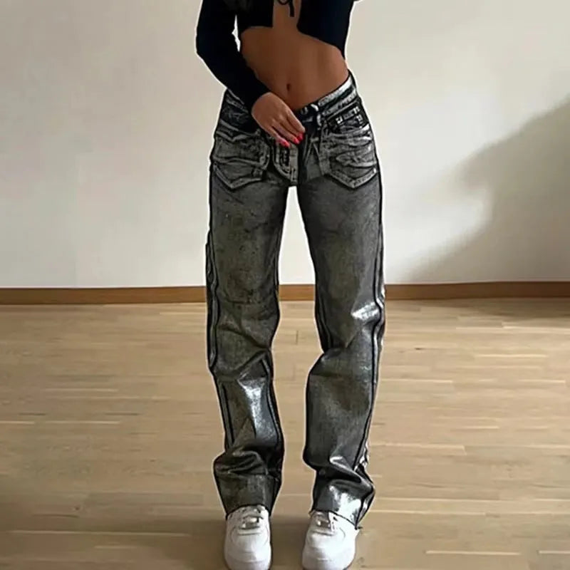 Washed blue high-waist straight-leg jeans with contrast colour detailing on a denim background.