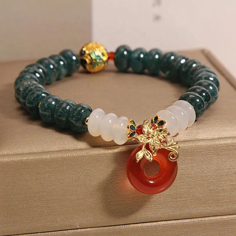 Women's crystal bracelet with blue water jade and red agate beads featuring safety buckle closure