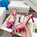 Women's black stiletto heel sandals with a silk bandage back strap and buckle closure.