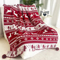 Personalised acrylic Christmas blanket with snowflake or reindeer pattern on a sofa.