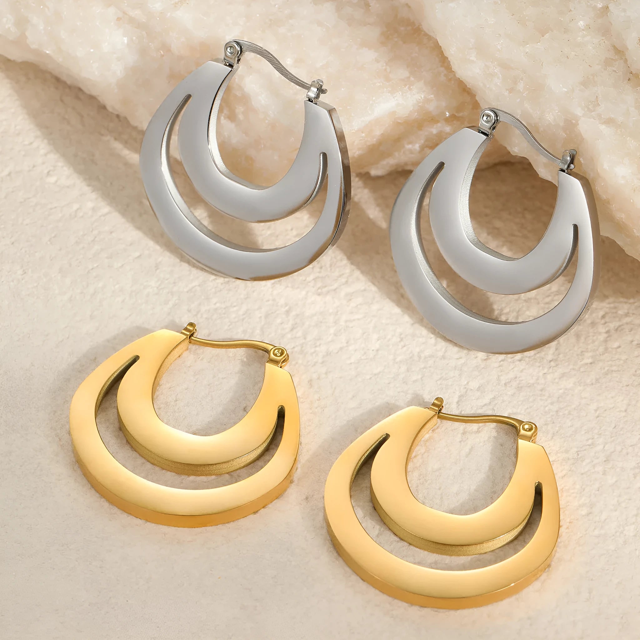 Geometric minimalist French earrings in gold and steel colours with round ring design elements