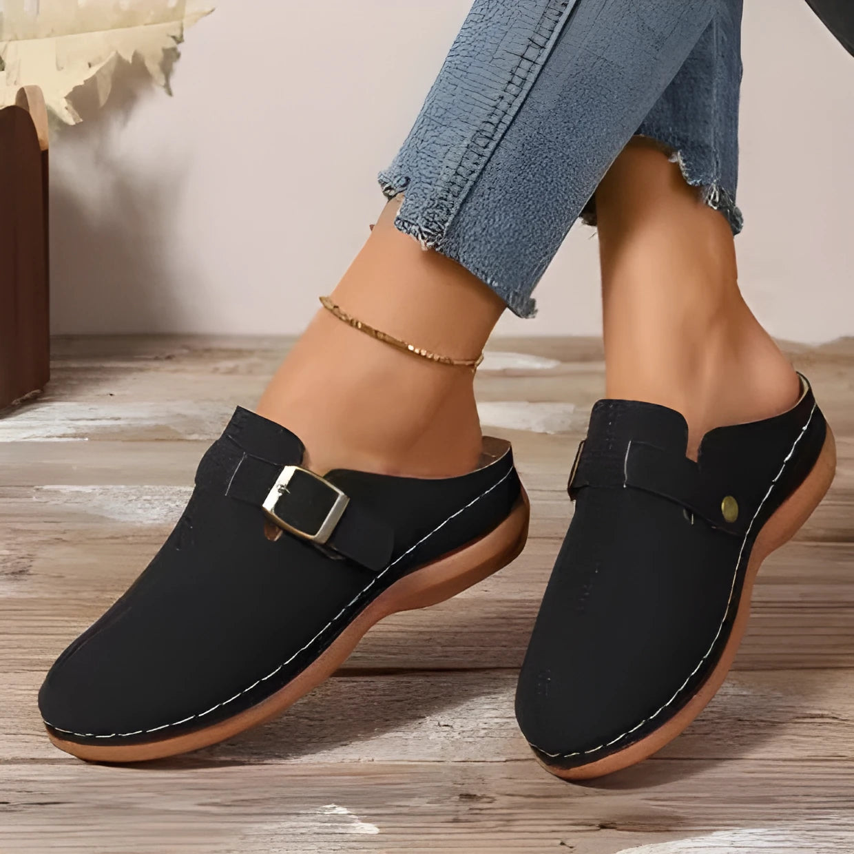 Women's casual wedge slippers in black with closed toe and rubber sole, shown from the side.