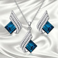Necklace and earrings jewellery set with alloy pendant and glass details on cross chain