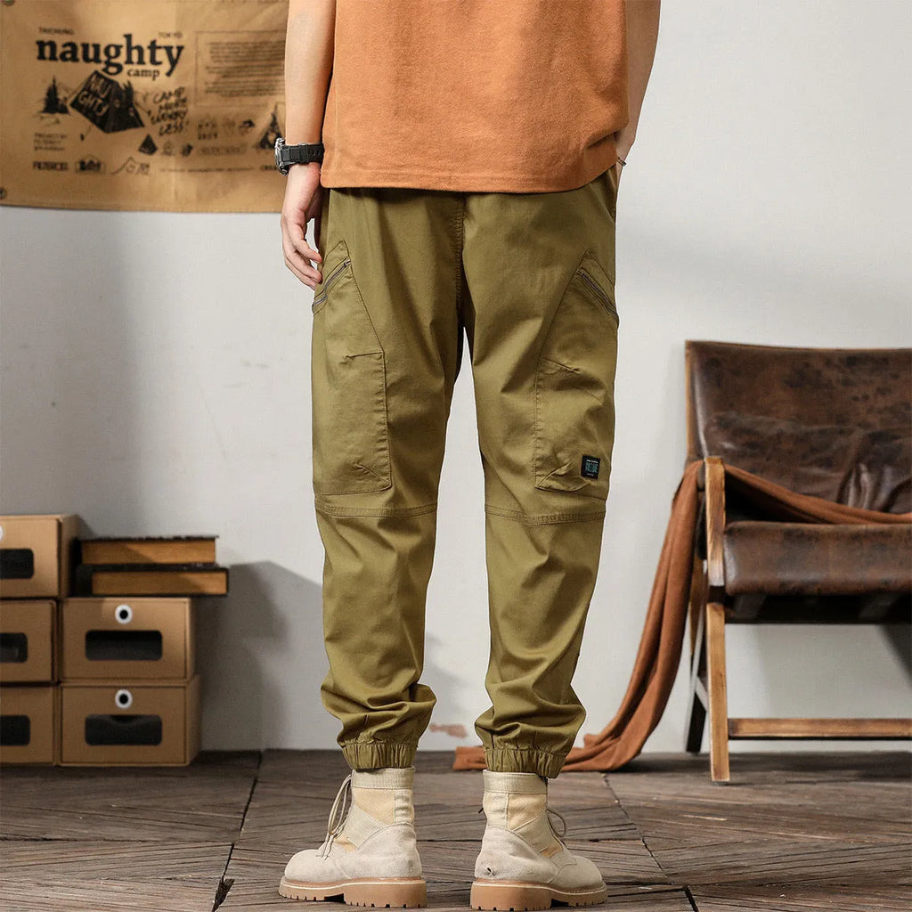 Men's khaki coloured loose fit cotton harem pants with a tapered ankle band.