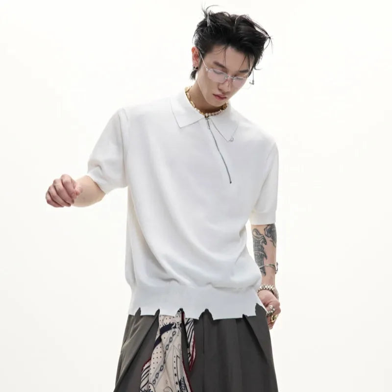 Man modelling a slim-fit black knitted polo shirt with an oblique zip and short sleeves.