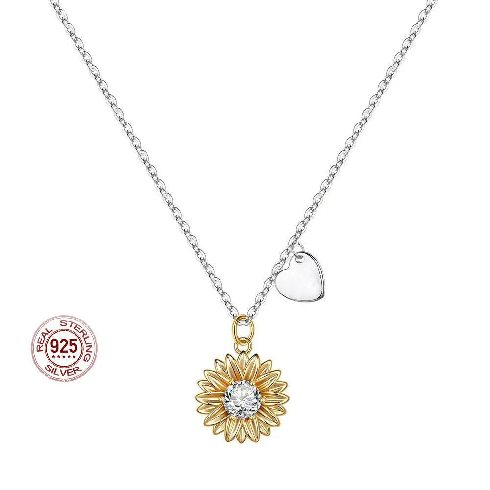 Women's sterling silver sunflower necklace with geometric petal pendant on a cross chain.