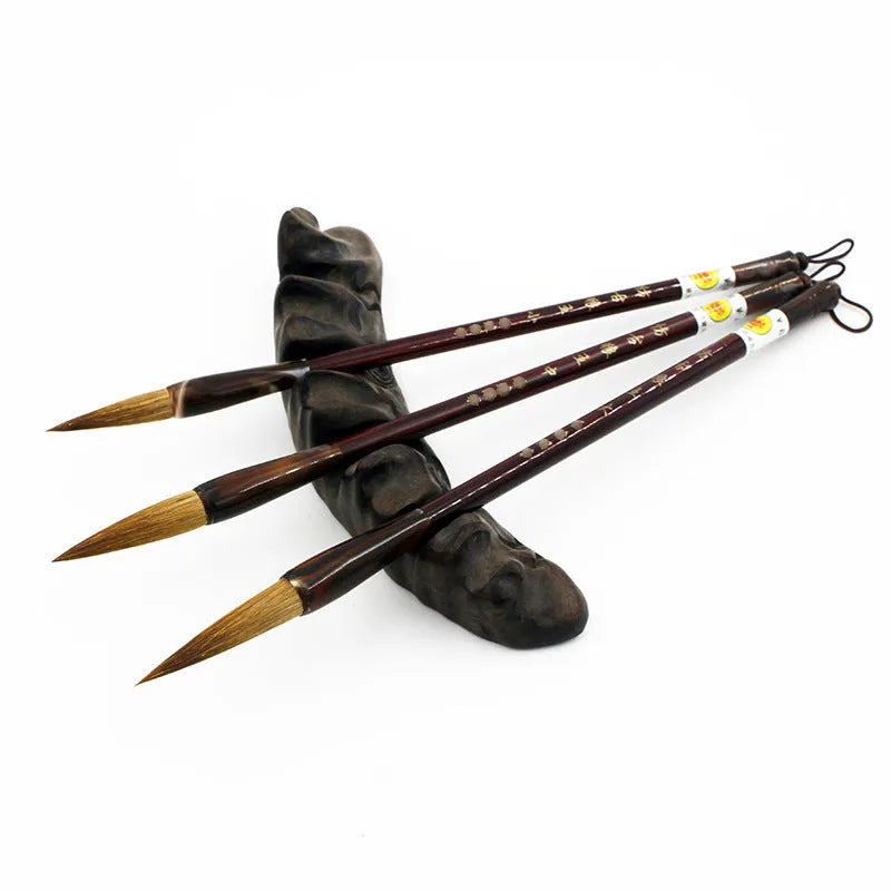 Traditional Chinese wolf hair calligraphy brushes with steel rod handles in large, medium, small, and trumpet sizes.