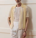 Yellow asymmetric hollow-out short sleeve polo shirt made from Tencel fabric on a model.
