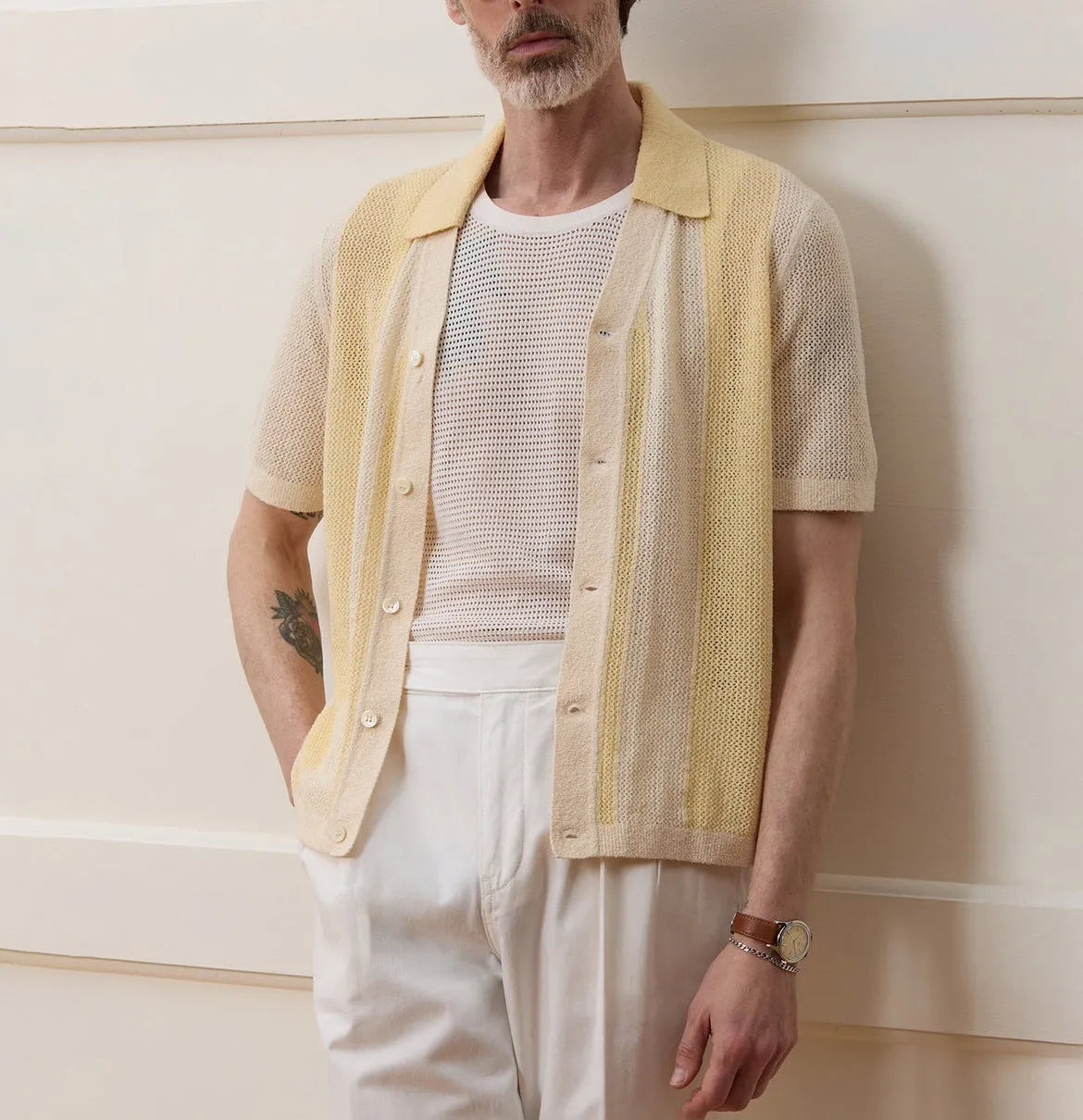 Yellow asymmetric hollow-out short sleeve polo shirt made from Tencel fabric on a model.