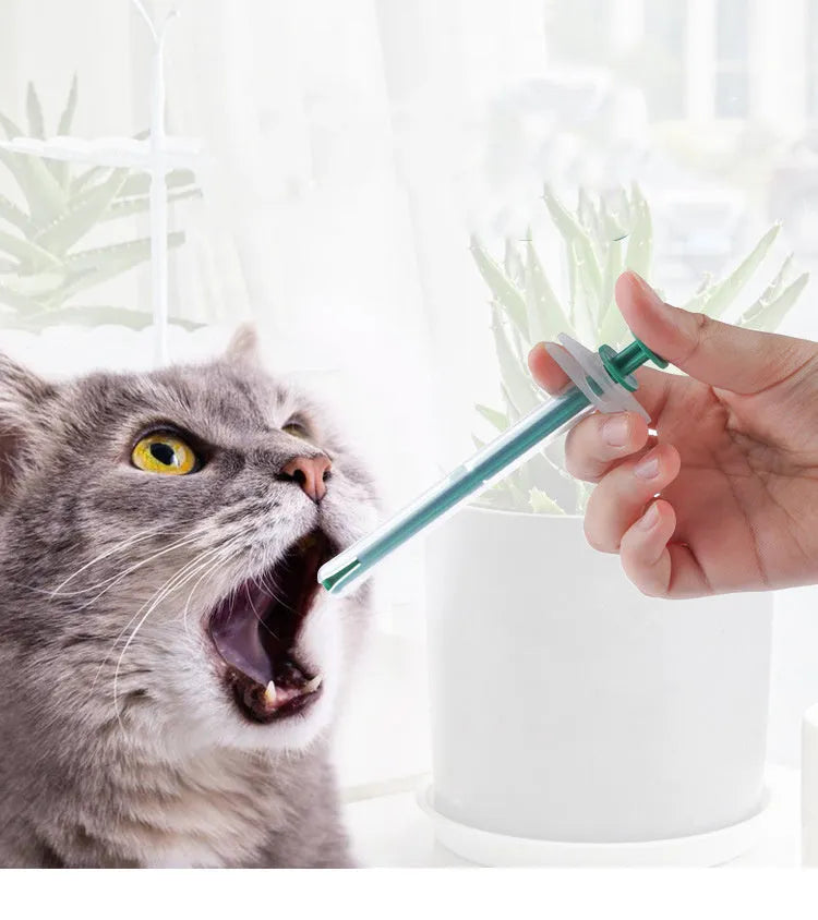 Two silicone pet pill shooters with soft tips, one larger and one smaller, for administering tablets to cats and dogs.