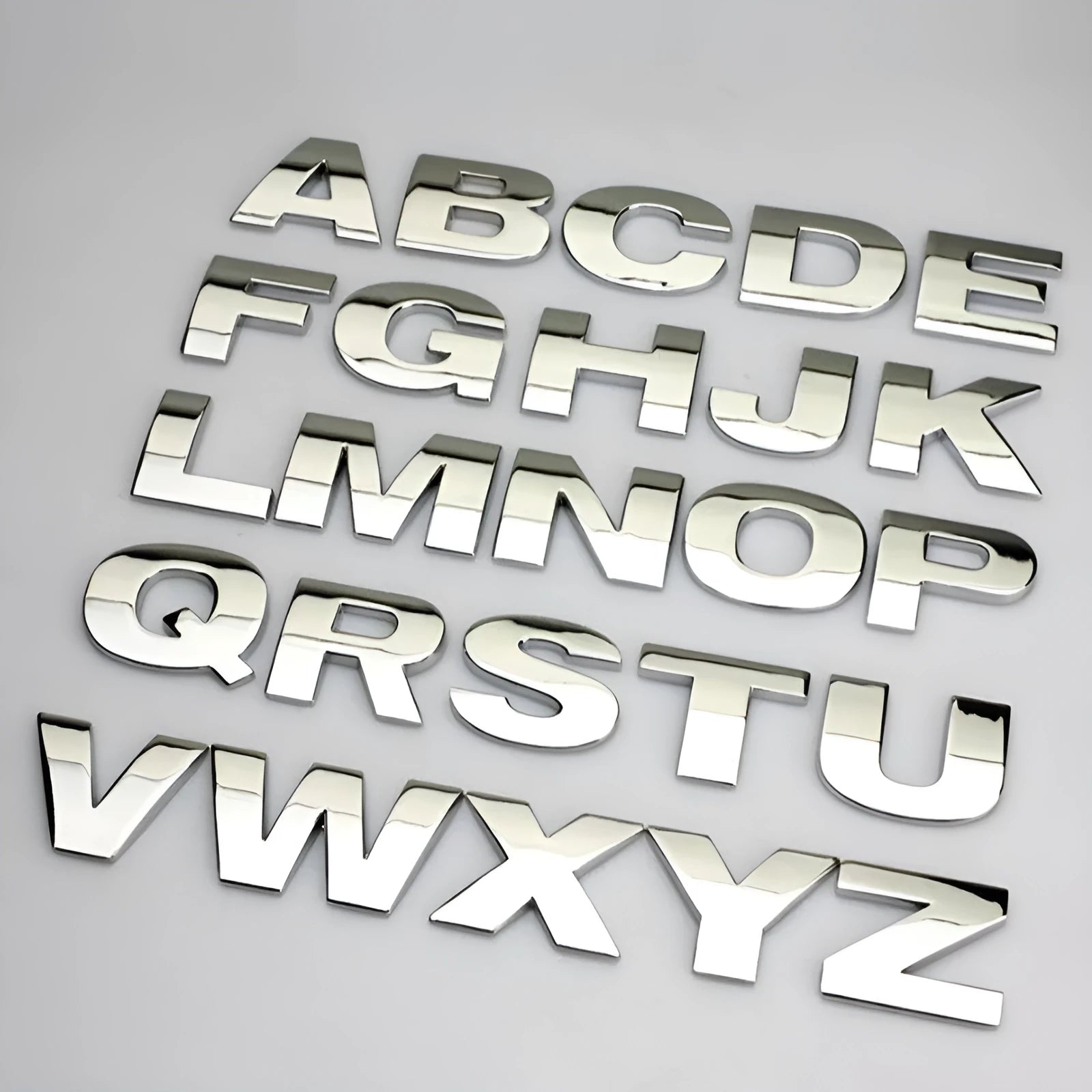 Metal zinc alloy car bumper sticker showing 2.5cm English letter on black background