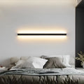 80cm long black aluminium in-line LED wall lamp with a PC shade on a white wall.
