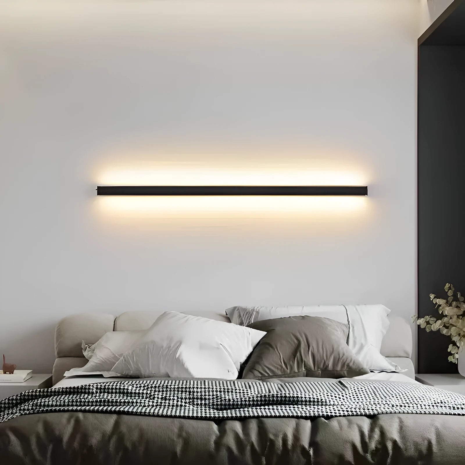 80cm long black aluminium in-line LED wall lamp with a PC shade on a white wall.