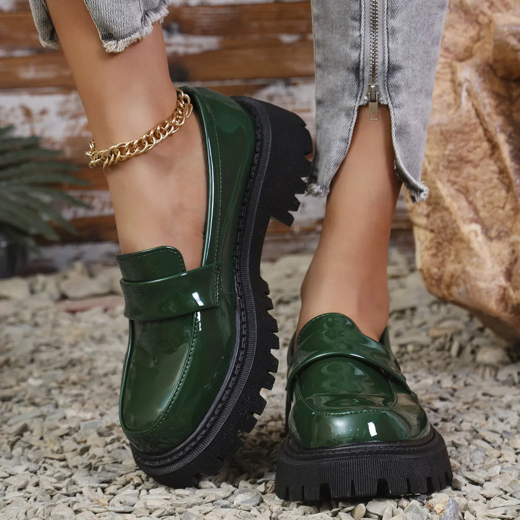 Women's plus size black slip-on loafers with a chunky mid-heel and rubber sole.