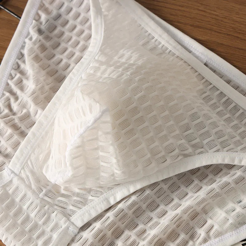 Men's low waist transparent lace underwear in multiple colours on a white background.