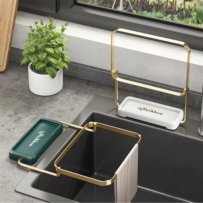 Foldable sink filter rack in dark green gold with disposable mesh bag on a stainless steel sink