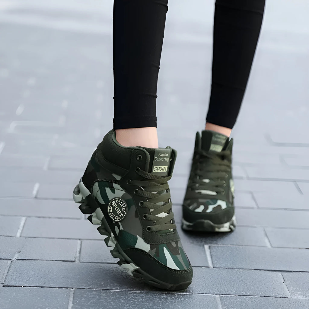 Women's green camouflage print canvas sneakers with a white rubber sole on a plain background.