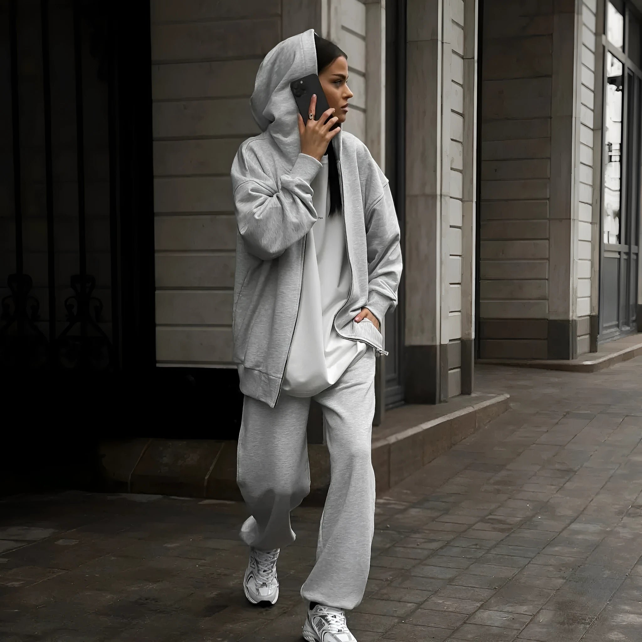 Street style loose fit two-piece set showing long-sleeved coat and matching trousers in solid colour